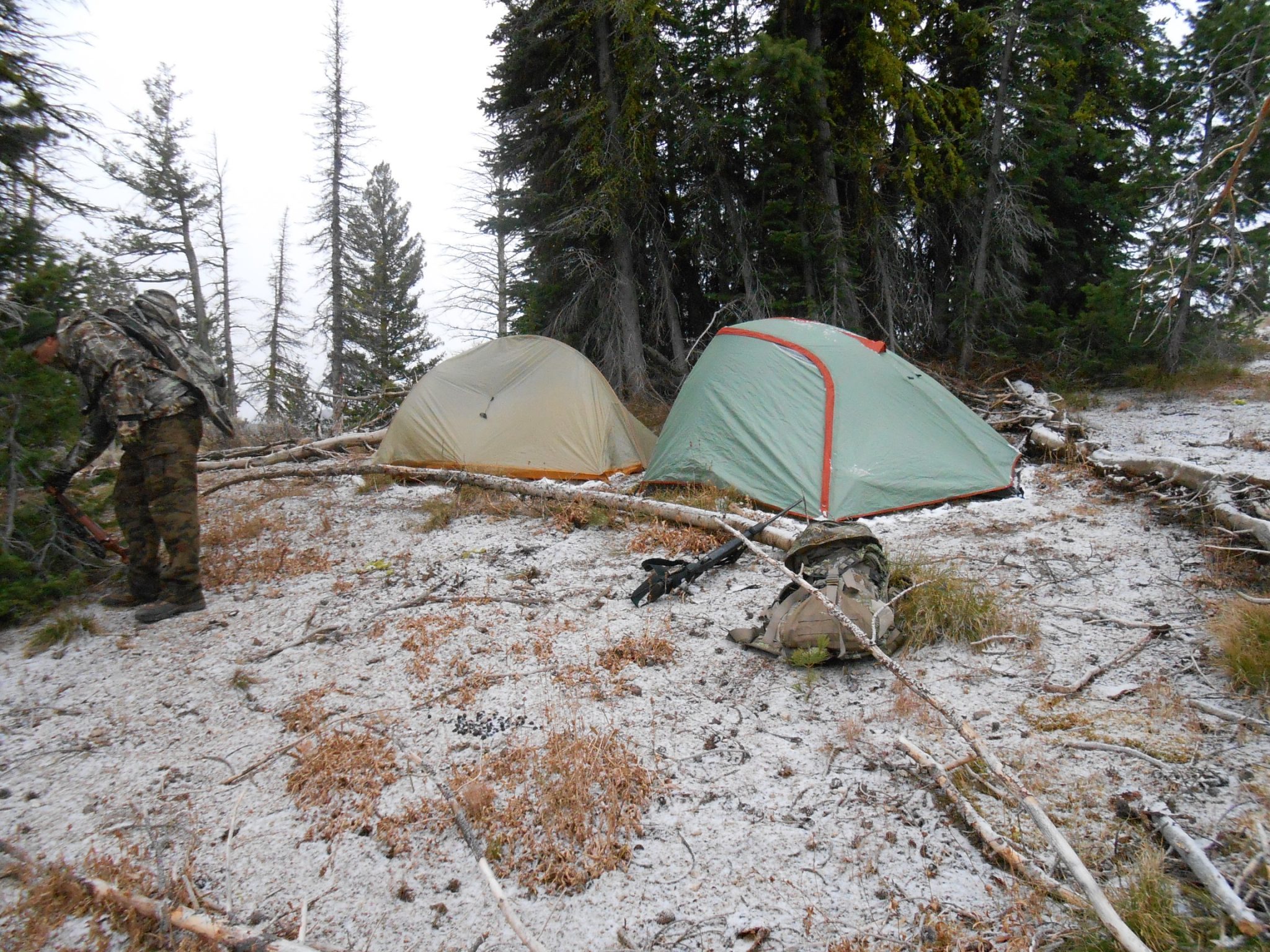 Camp tucked out of view from a high-country basin