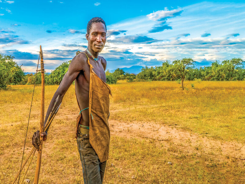 HADZA MAN WITH HIS BOW AND ARROWS (WITH PHOTO CREDIT)