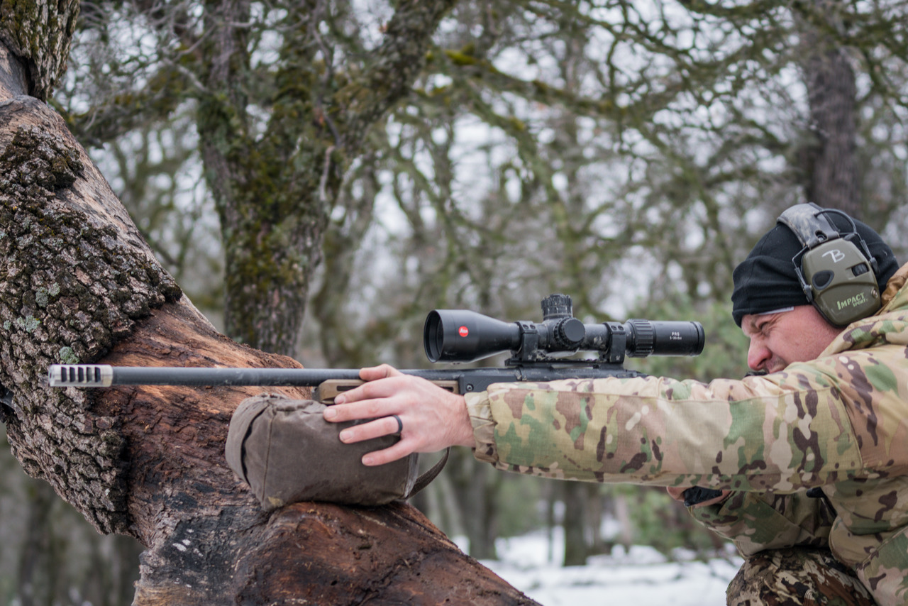 Author shooting against a tree