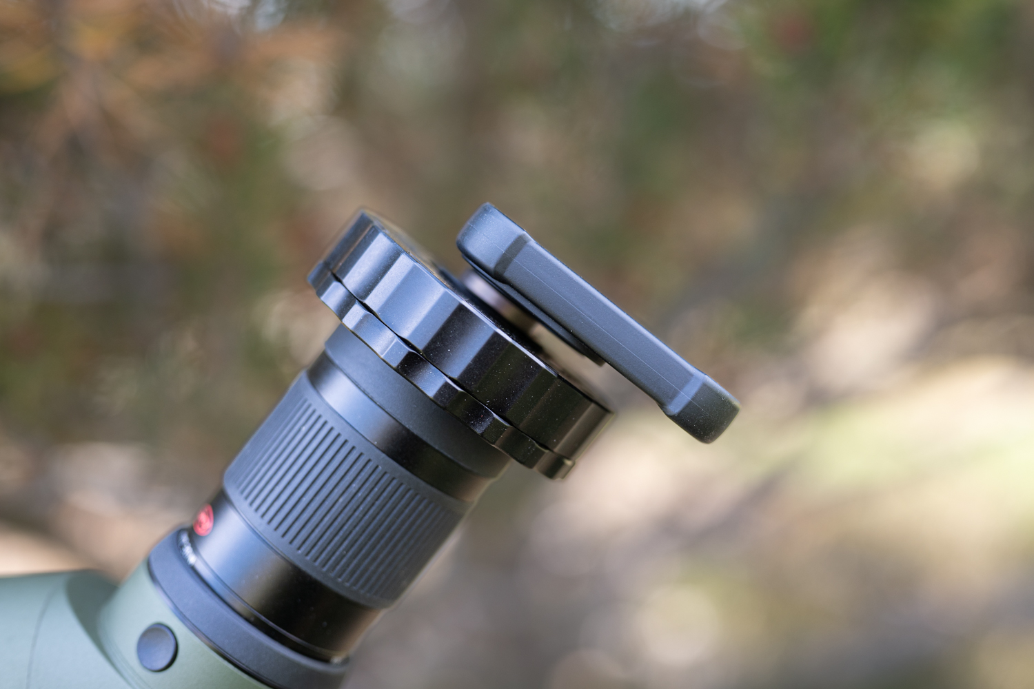 A phone digiscoping adapter lines up the phone’s camera lens to the eyepiece.