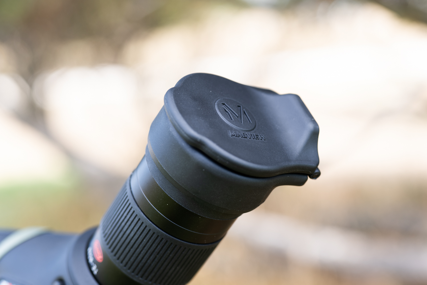 The Magview hinged cap does double duty protecting the eyepiece and folding out to hold the phone case magnetically.