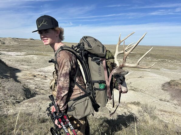 Writer's son with a mule deer buck.