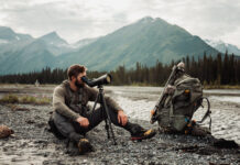 The Next Level in Optics with Ryan Holm of Leica Man looks through Leica spotting scope in the mountains on a hunt