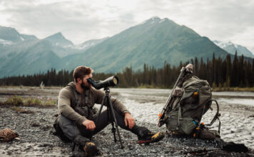The Next Level in Optics with Ryan Holm of Leica Man looks through Leica spotting scope in the mountains on a hunt